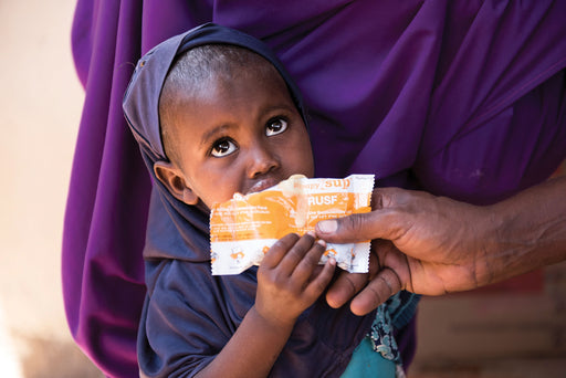 A child drinks life saving fortified soup.