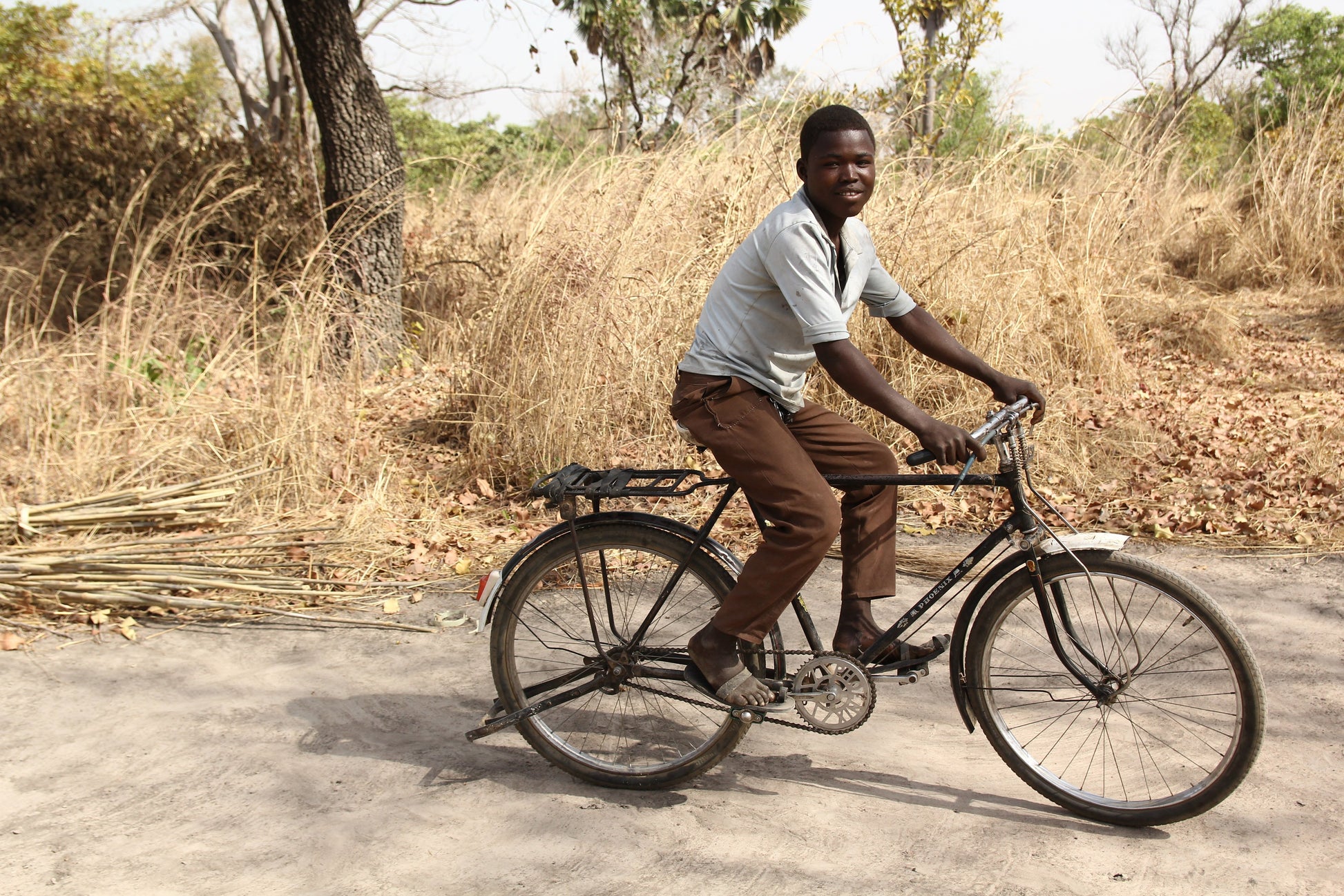 boy in a white shirt riding a bicycle 
